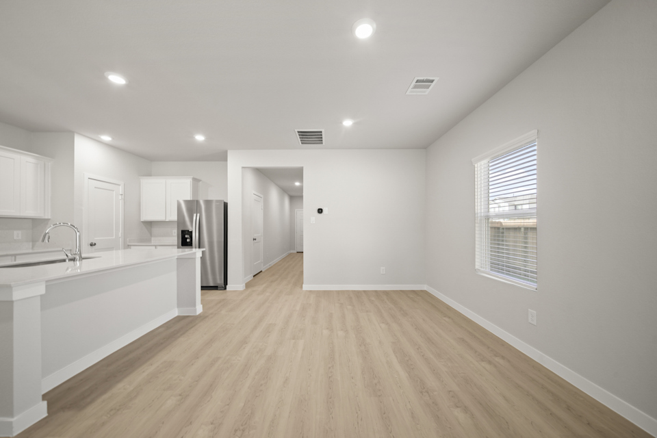 A kitchen with white cabinets.