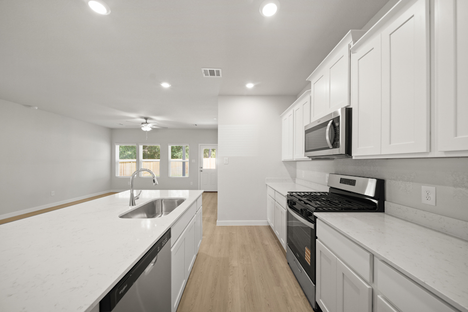A kitchen with white cabinets.