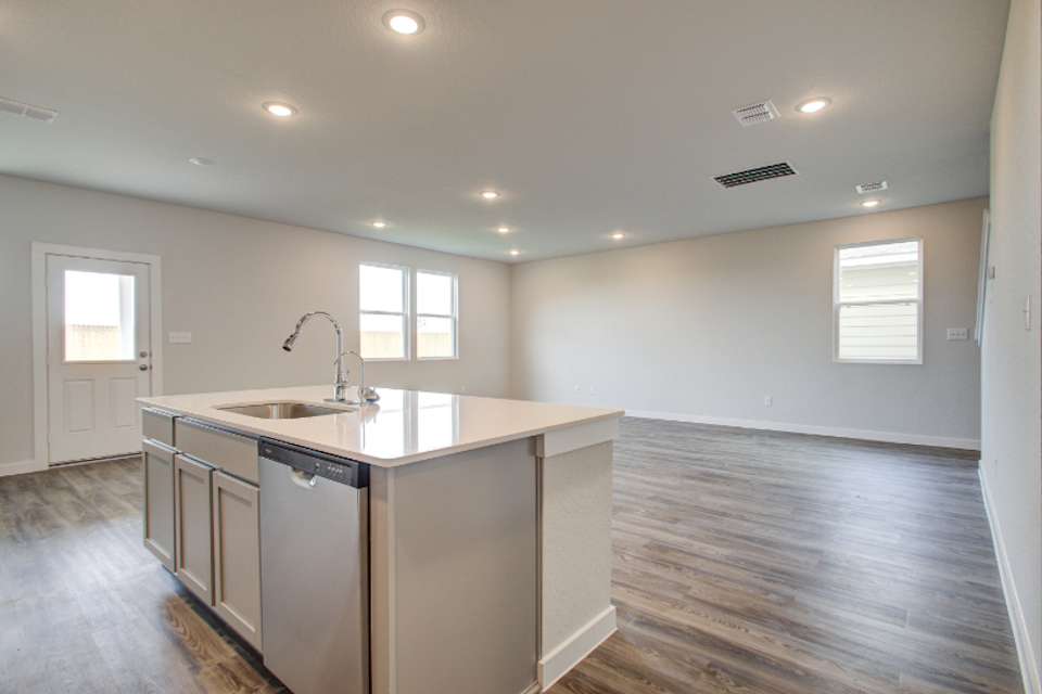 A kitchen with a sink and cabinets.