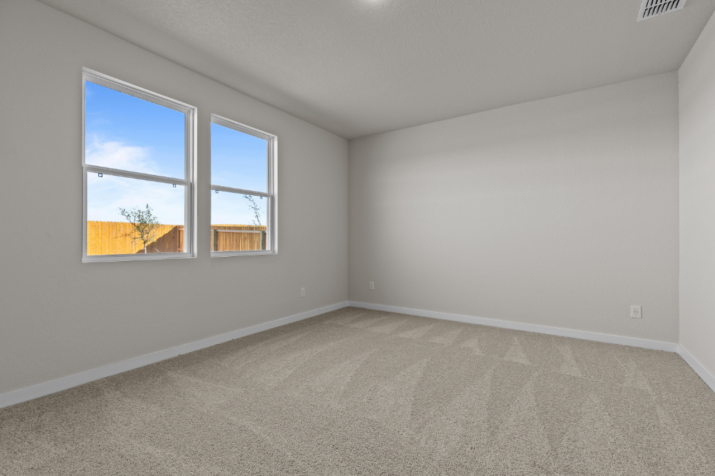 A room with a window and a carpet.