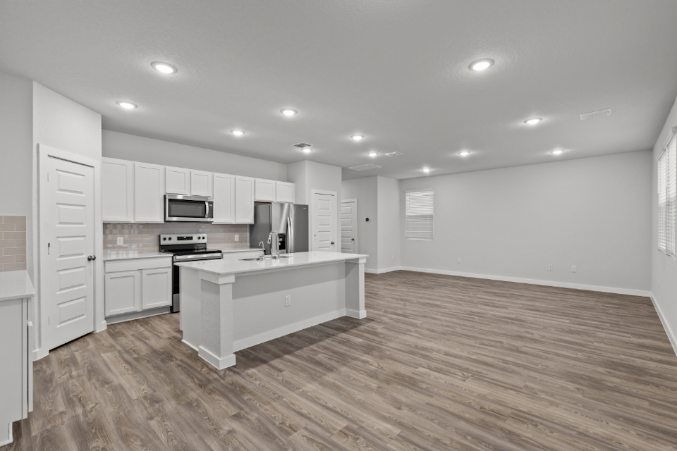 A kitchen with white cabinets.