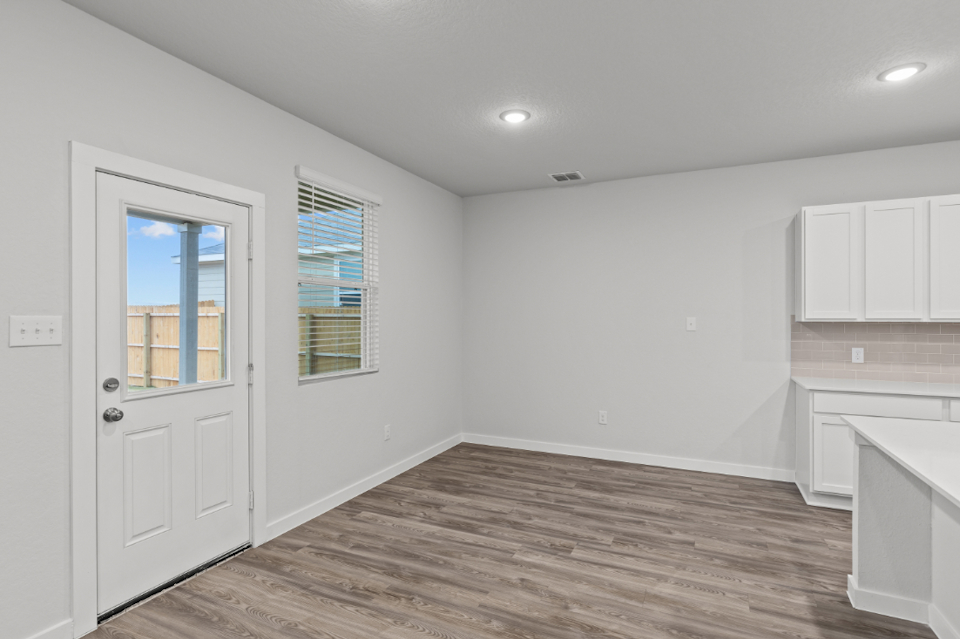 A room with white walls and a wood floor.