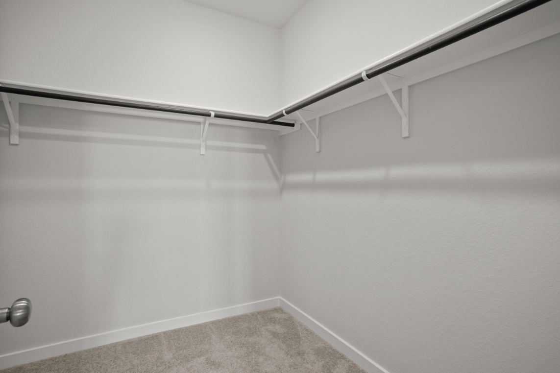 A white wall with a metal railing.