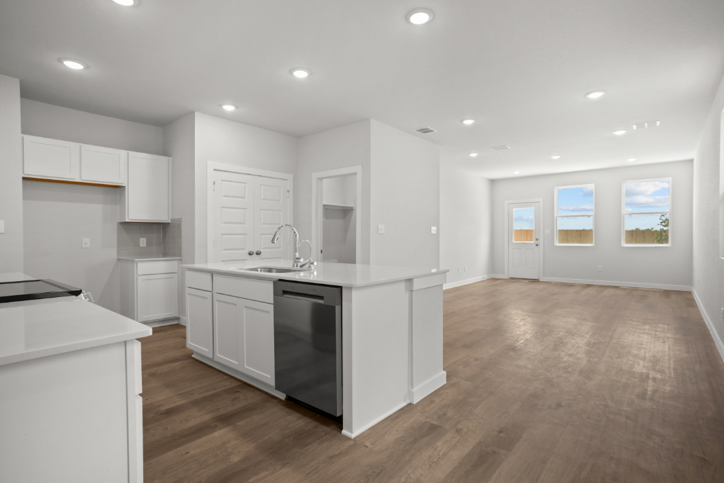 A kitchen with white cabinets.