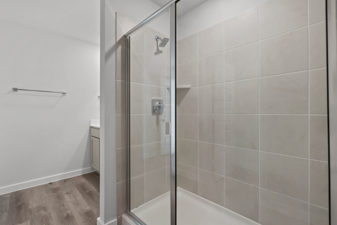 A shower with a glass door.