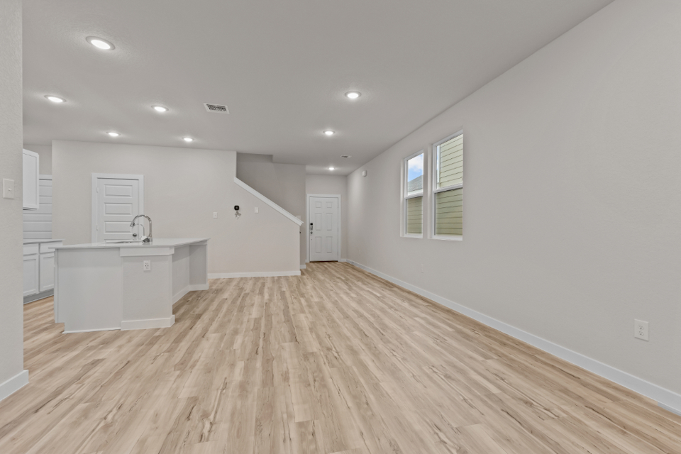 A room with white walls and a wood floor.
