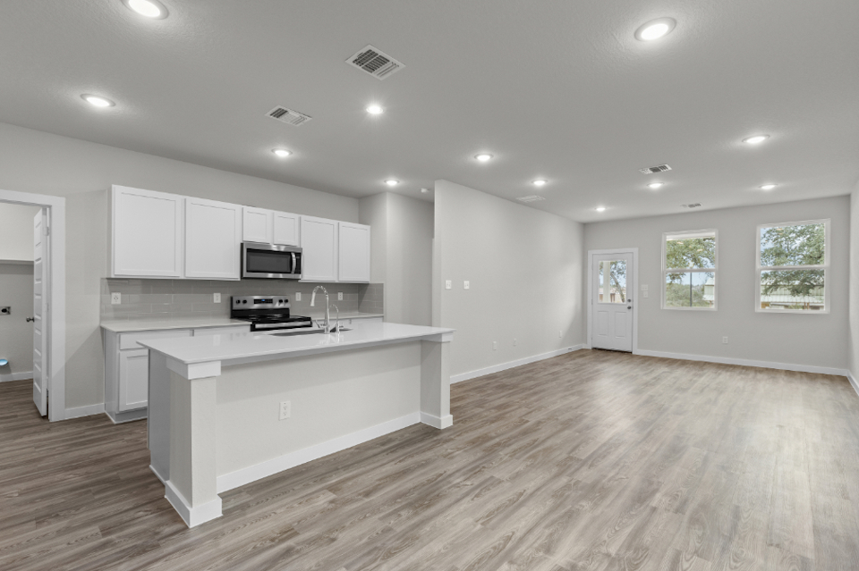 A kitchen with white cabinets.