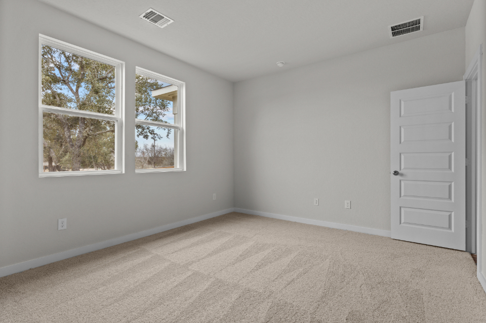 A room with white walls and windows.