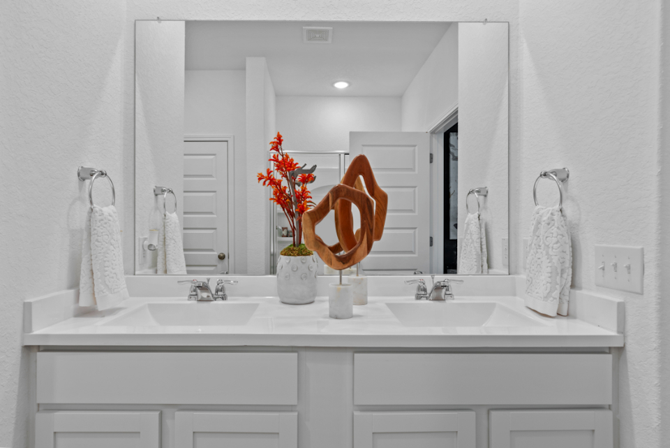 A bathroom with a large mirror.