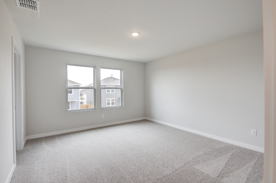 A room with a window and a carpet.