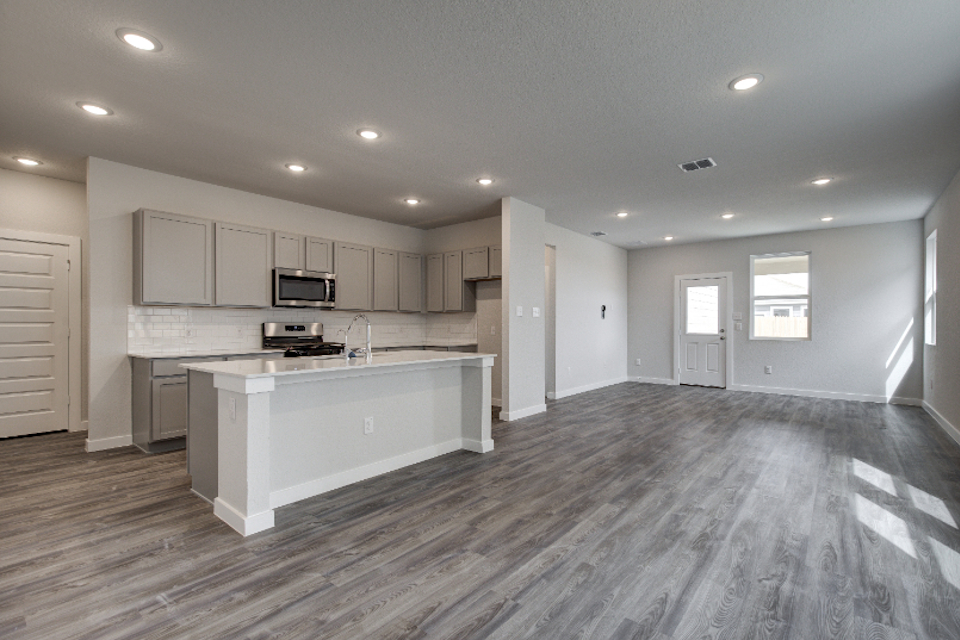 A kitchen with white cabinets.