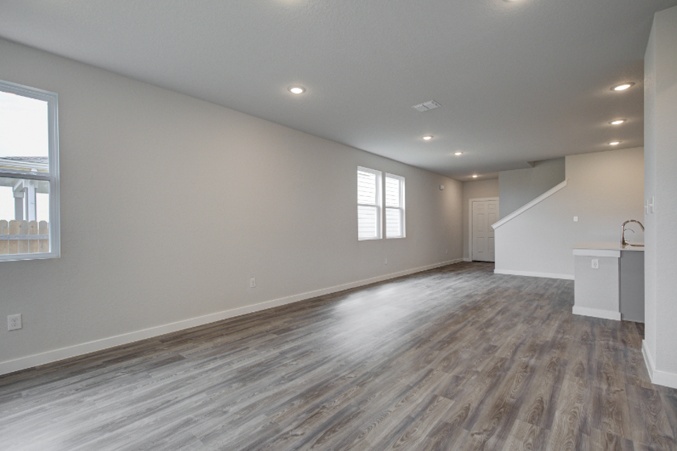 A room with a wood floor and windows.