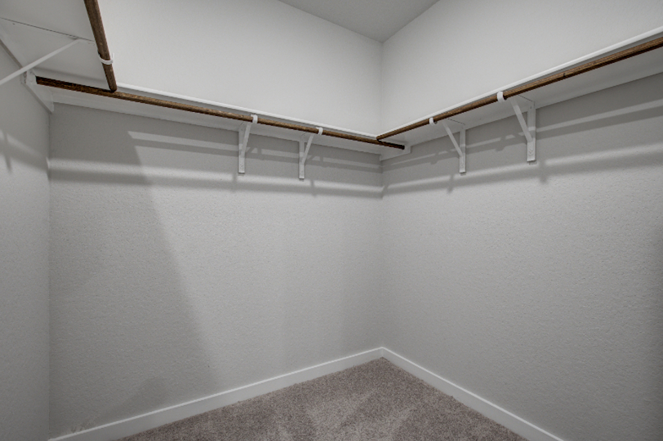 A white staircase with a white wall.