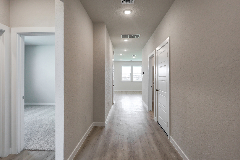 A hallway with white doors.