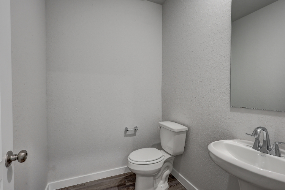 A bathroom with a toilet and sink.