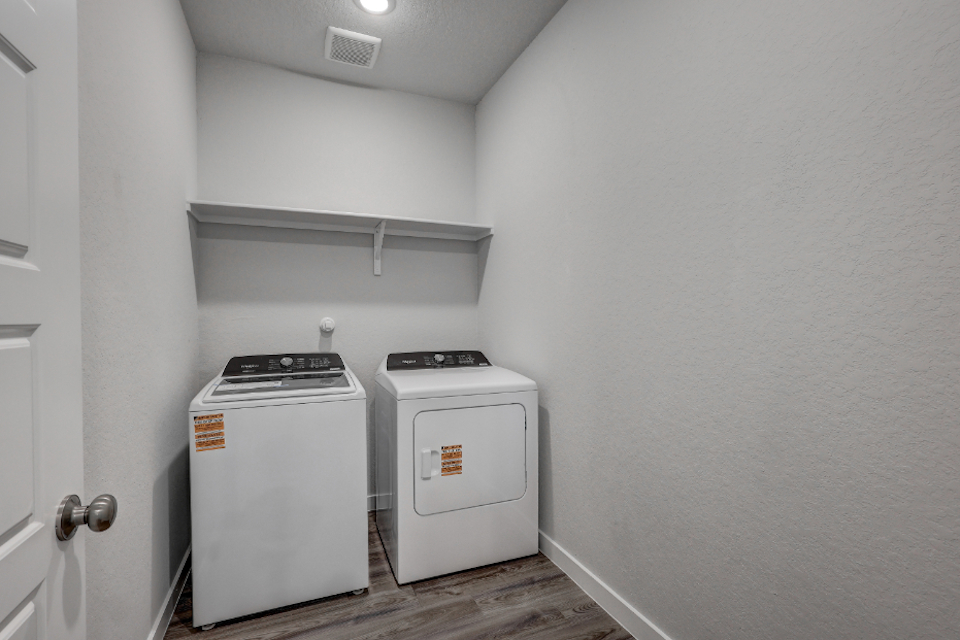 A small kitchen with a washer and dryer.