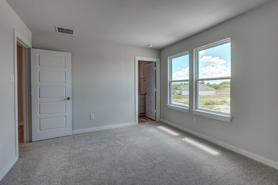 A room with white walls and a window.