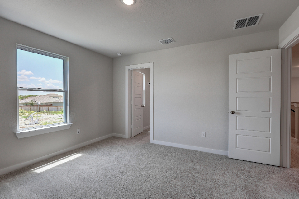 A room with white walls and a window.