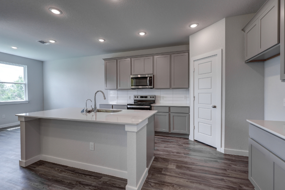A kitchen with white cabinets.