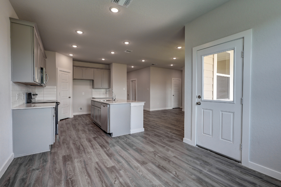 A large kitchen with white cabinets.