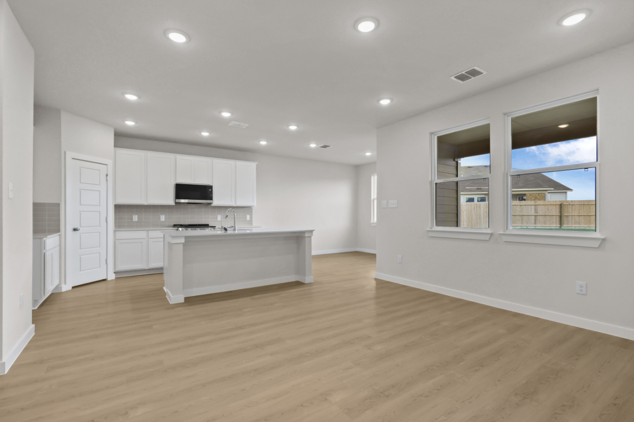 A kitchen with white cabinets.