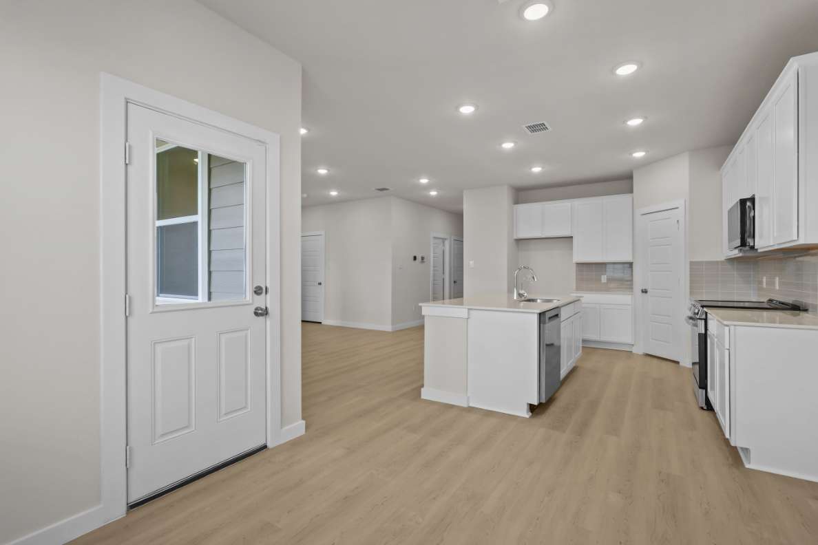 A kitchen with white cabinets.