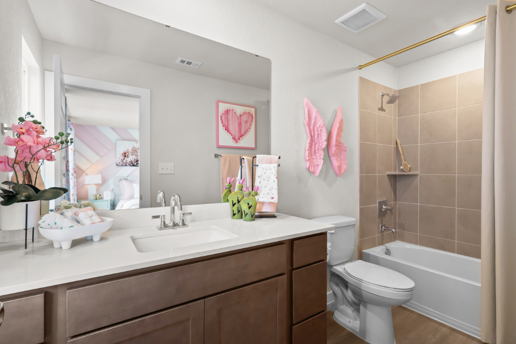 A bathroom with a sink toilet and bathtub.