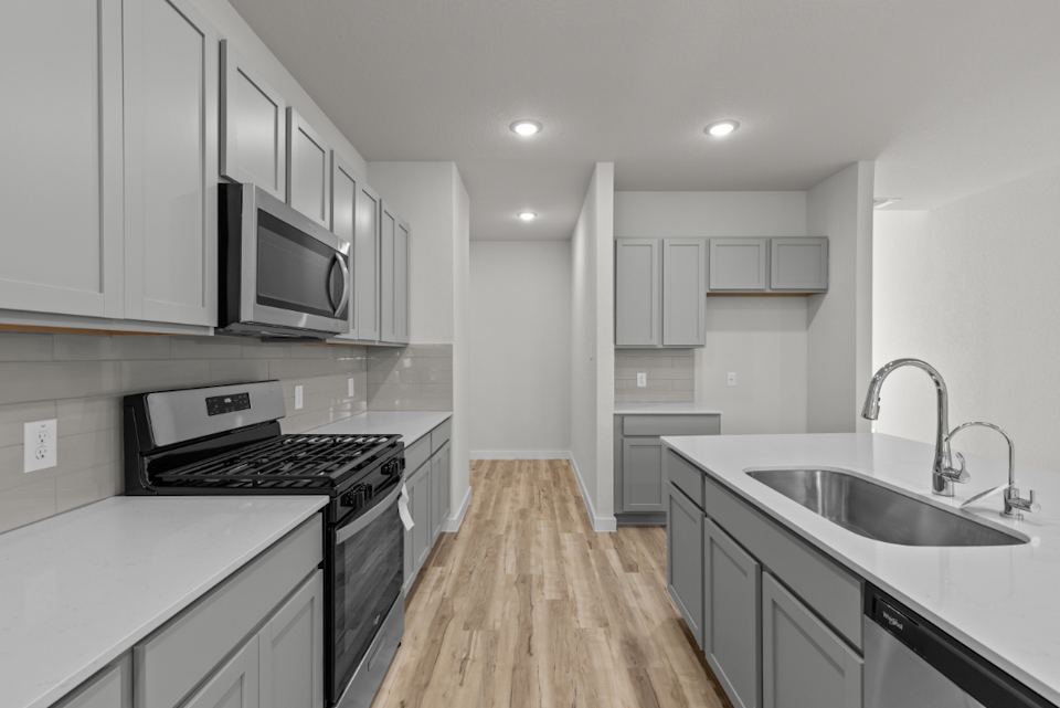 A kitchen with white cabinets.