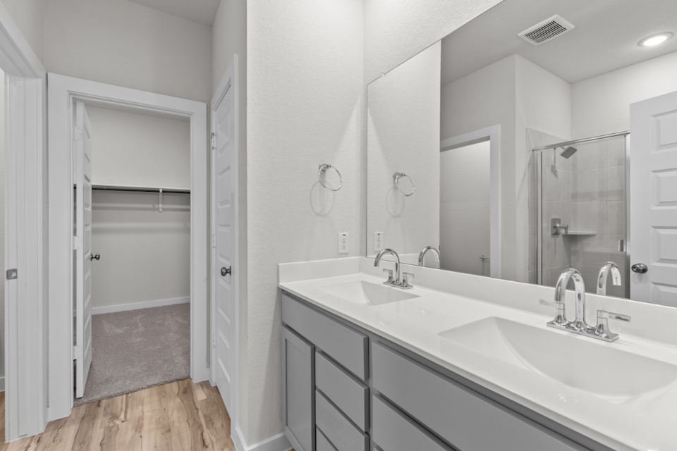 A bathroom with a large mirror.