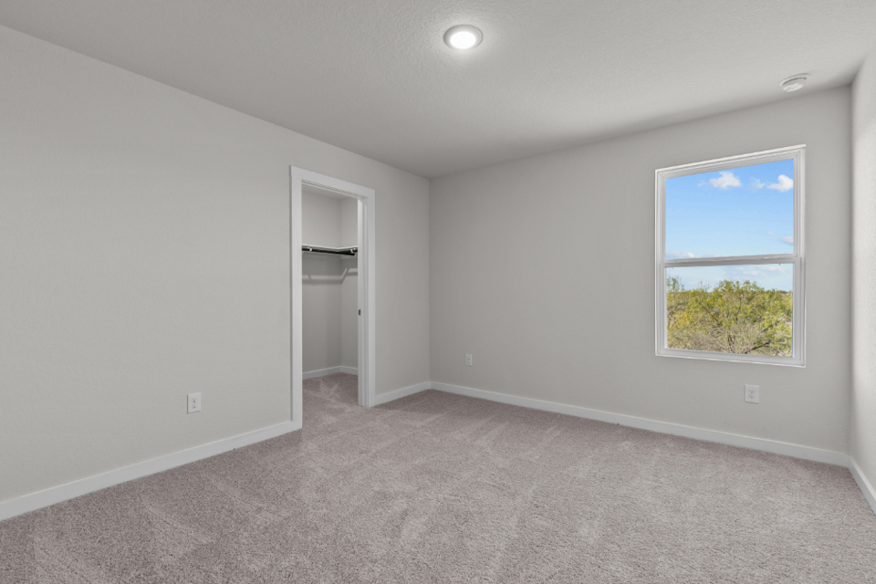 A room with a window and a shelf with a window.