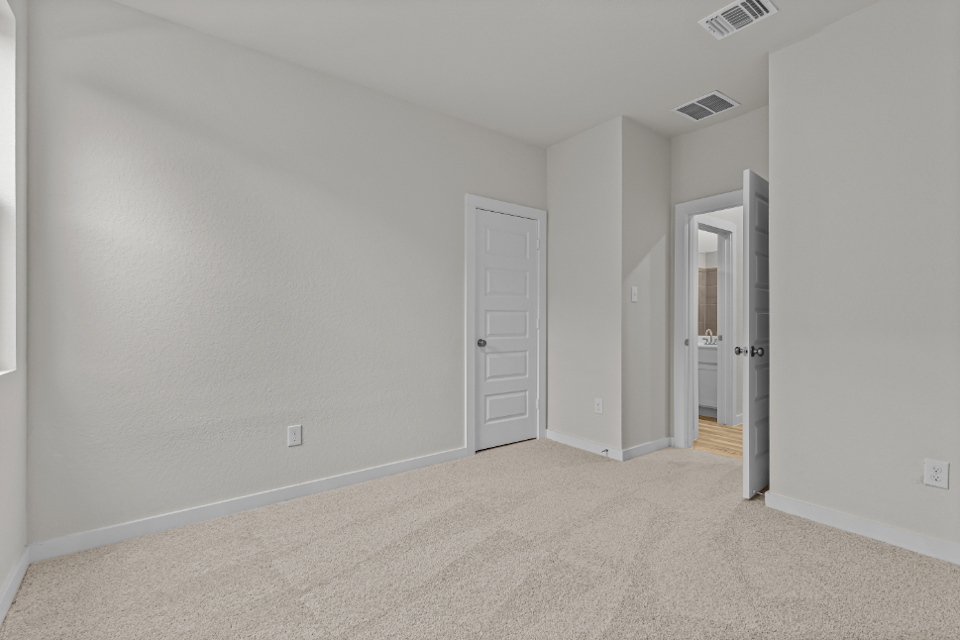 A hallway with white doors.