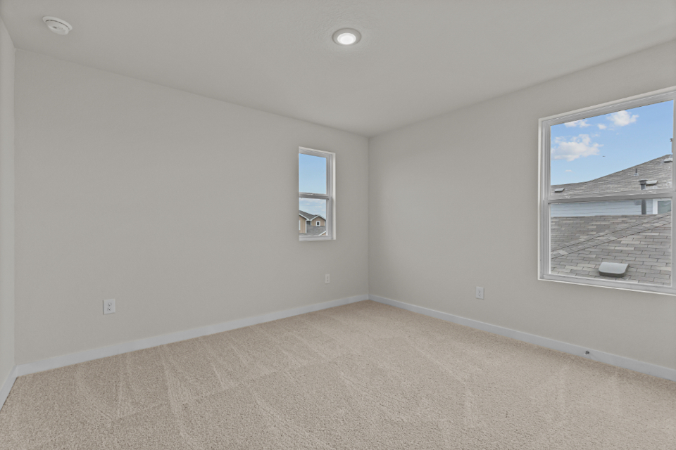 A room with a window and a carpet.