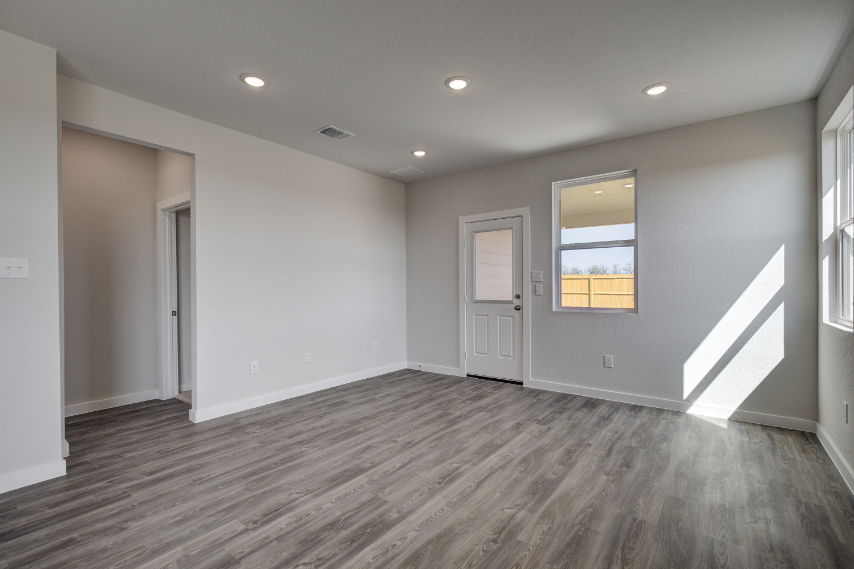 A room with white walls and a wood floor.