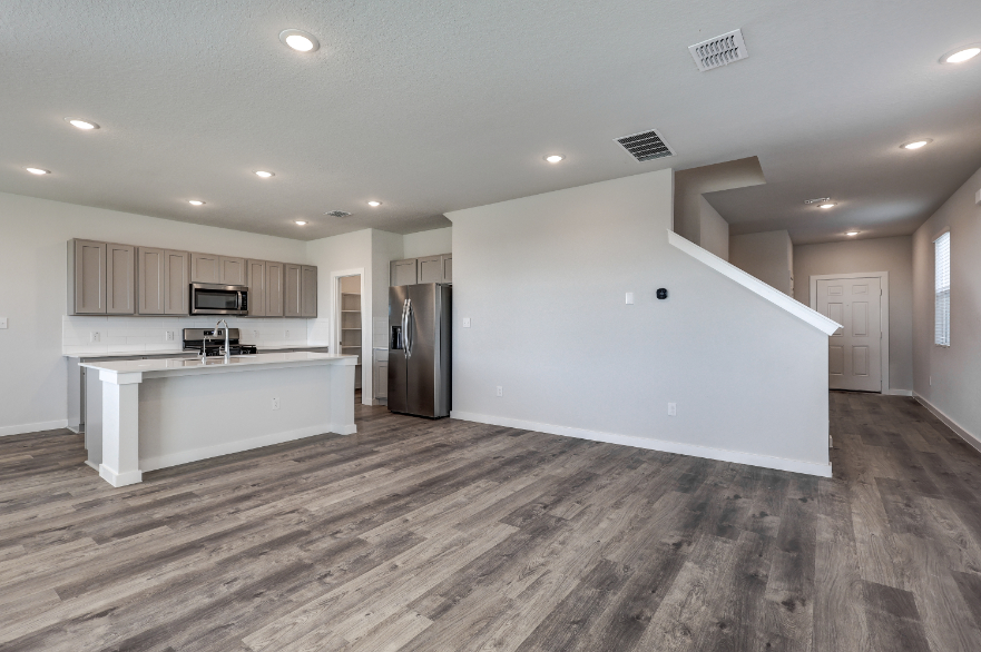 A kitchen with white cabinets.