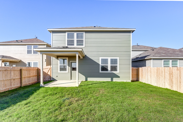 A house with a fence and grass.