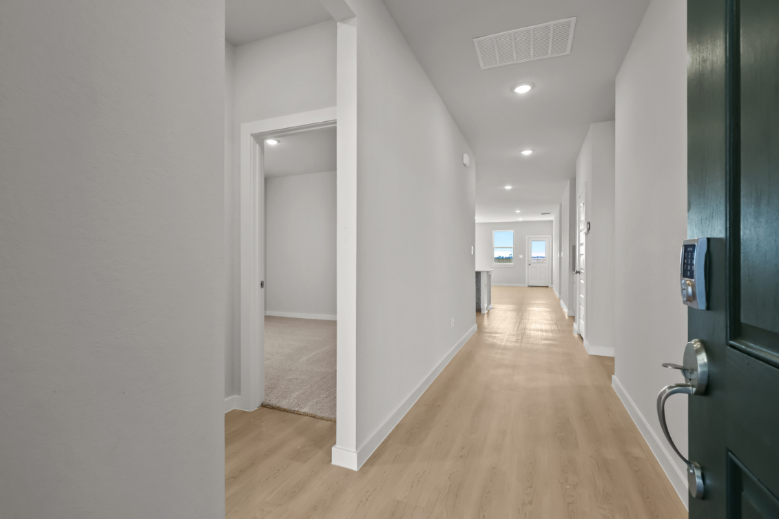 A hallway with white walls.