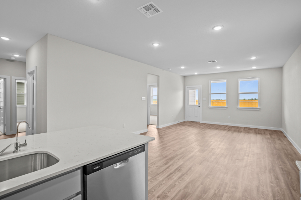 A kitchen with a wood floor.