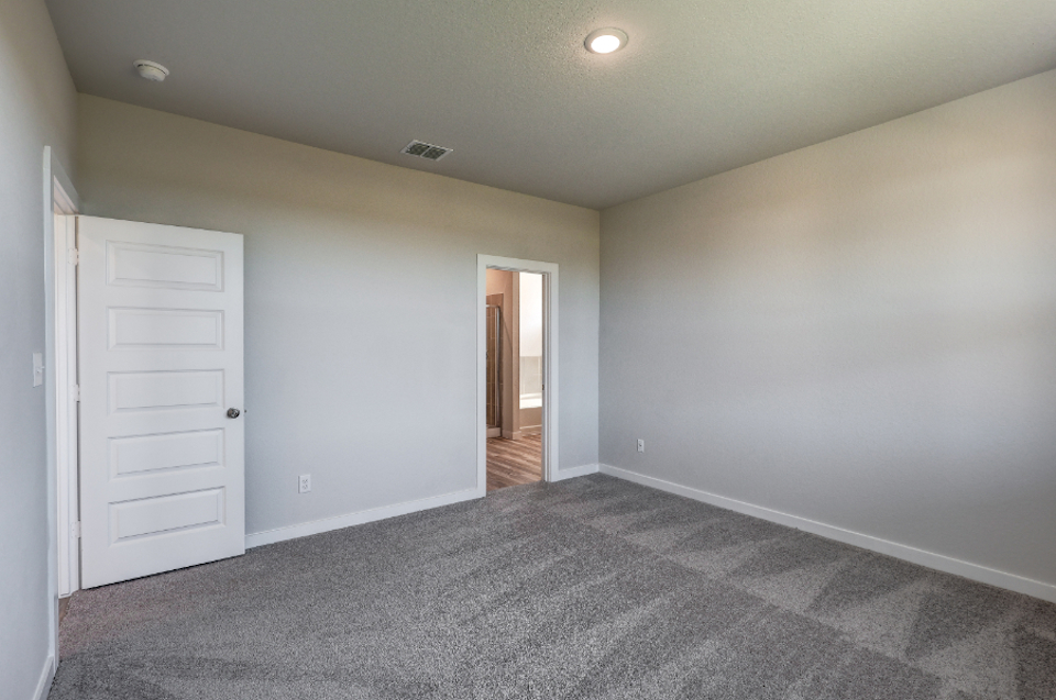 A hallway with white doors.
