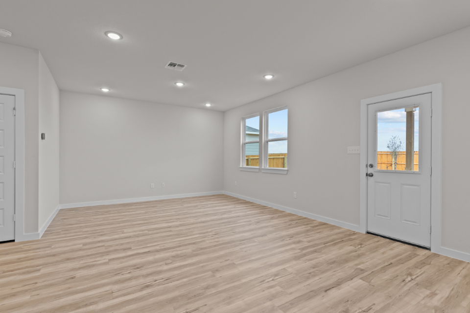 A room with a wood floor and white walls.