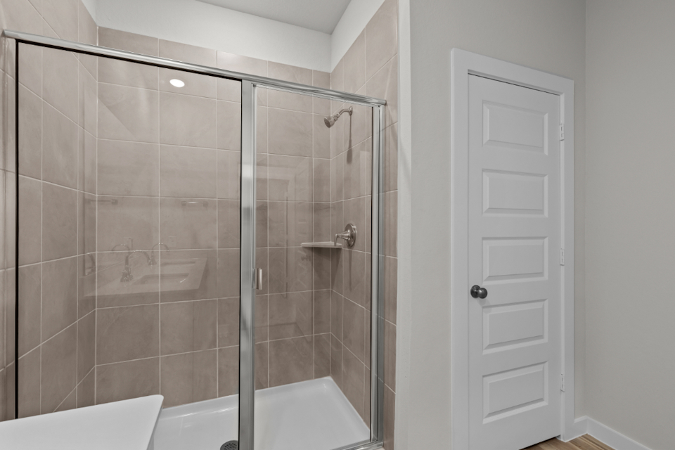 A shower with a glass door.