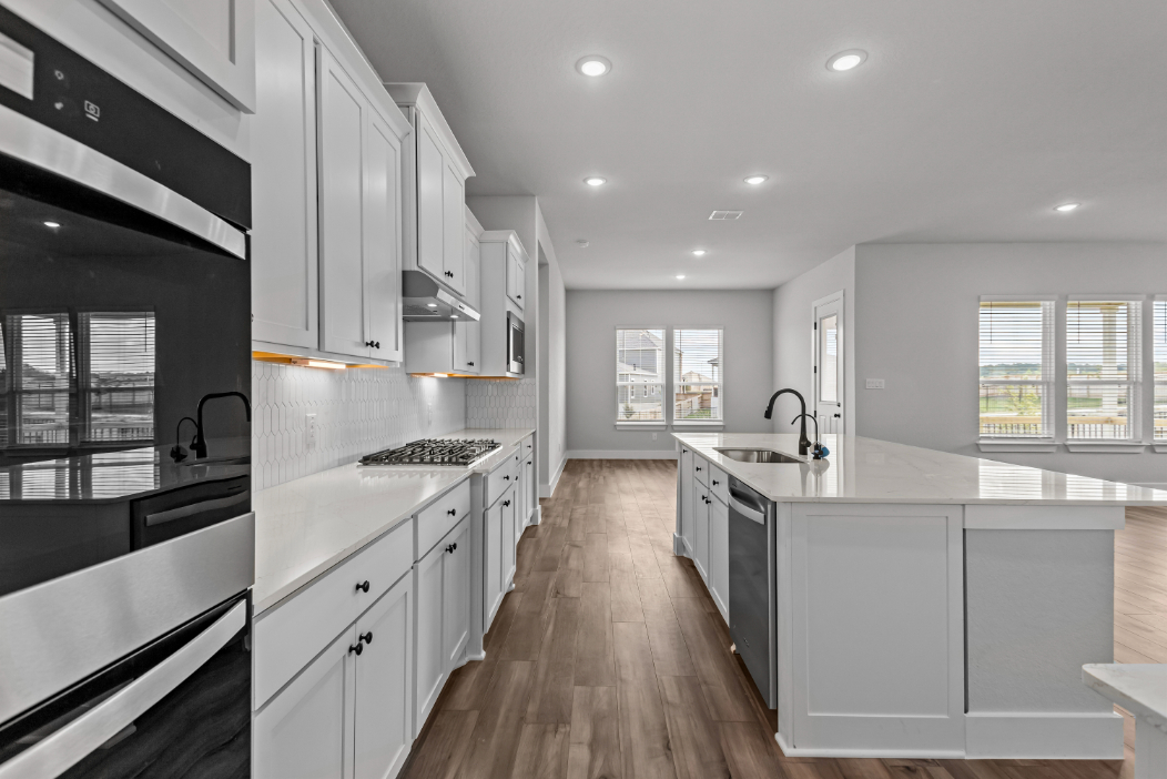 A kitchen with black cabinets.