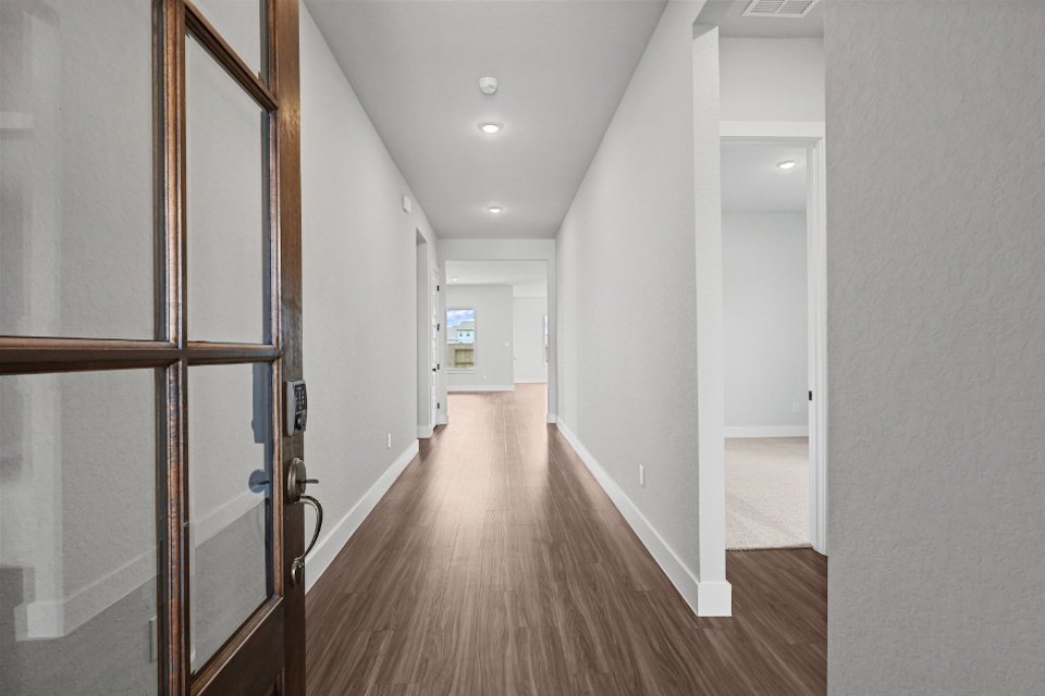 A hallway with glass doors.