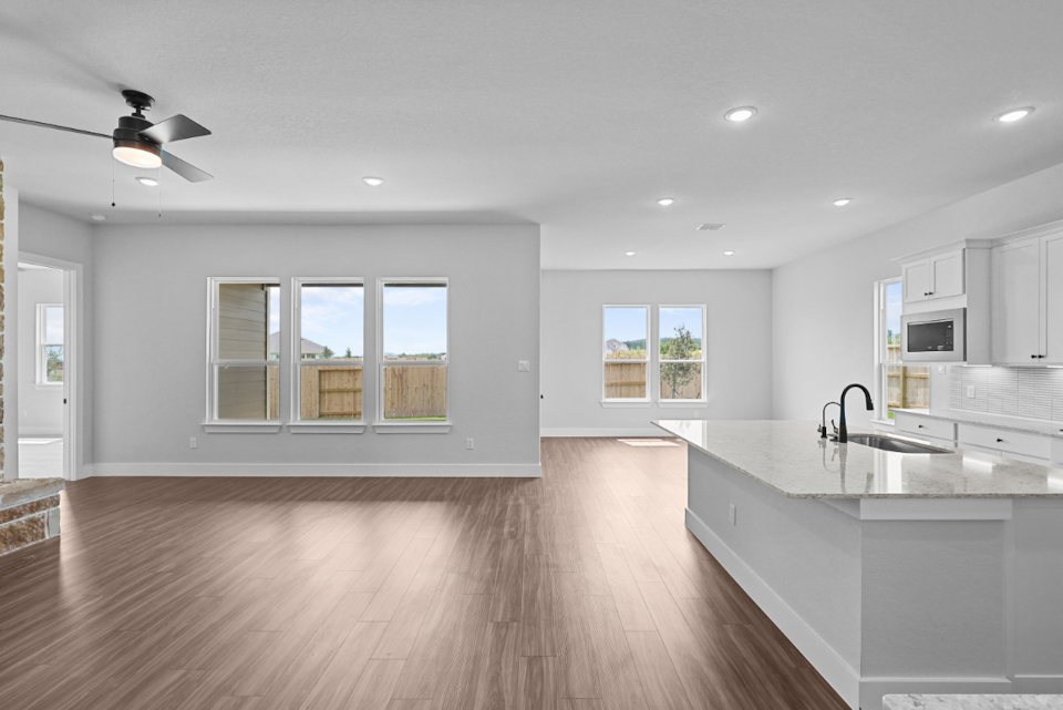 A kitchen with white cabinets.