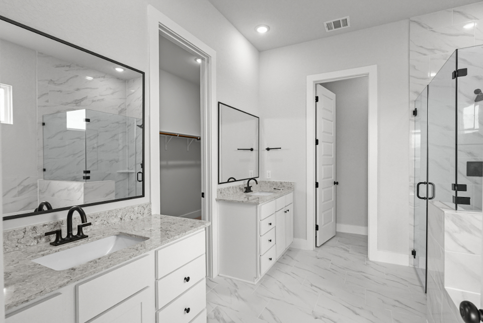 A bathroom with a large mirror.