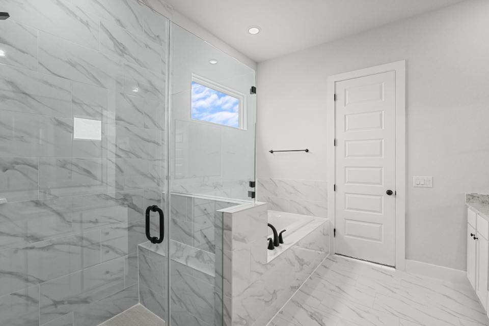 A bathroom with a glass shower.