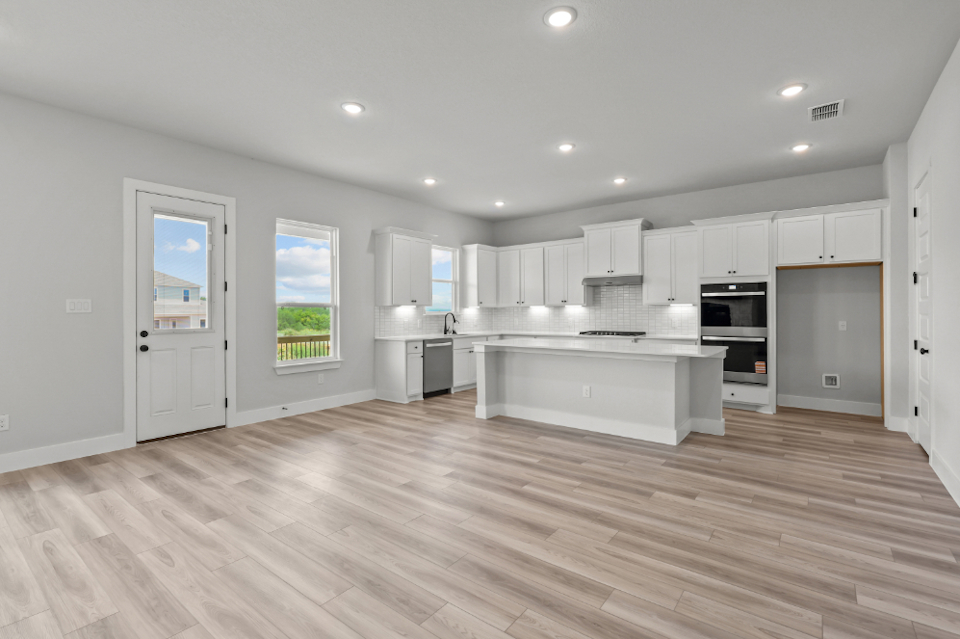 A kitchen with white cabinets.