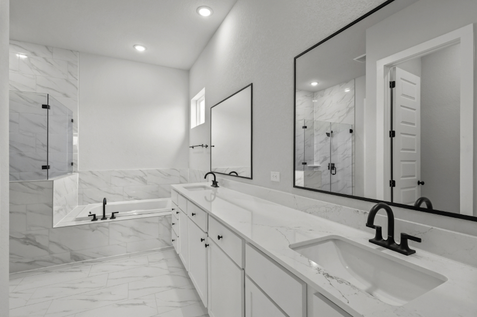 A bathroom with a large mirror.