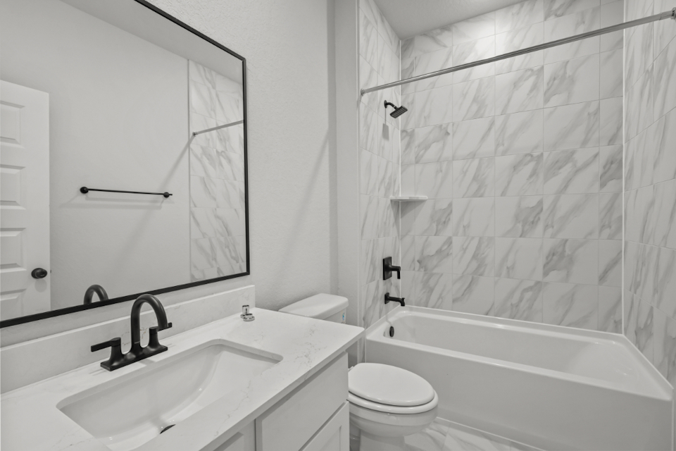 A bathroom with a shower and sink.