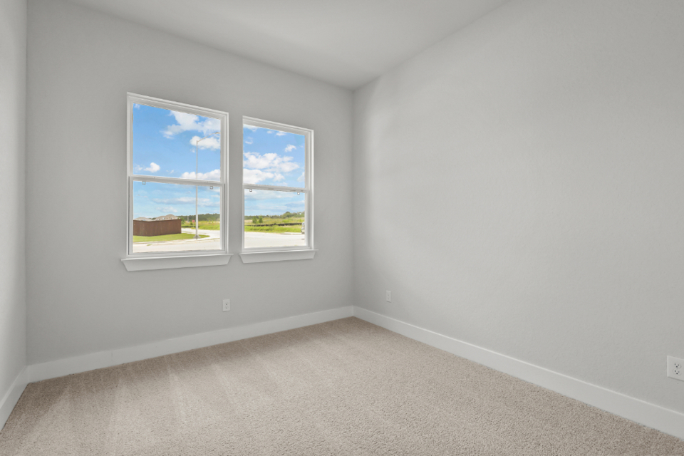 A room with a window and a white wall with a white wall.
