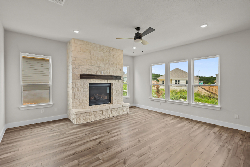 A room with a fireplace and a wood floor.